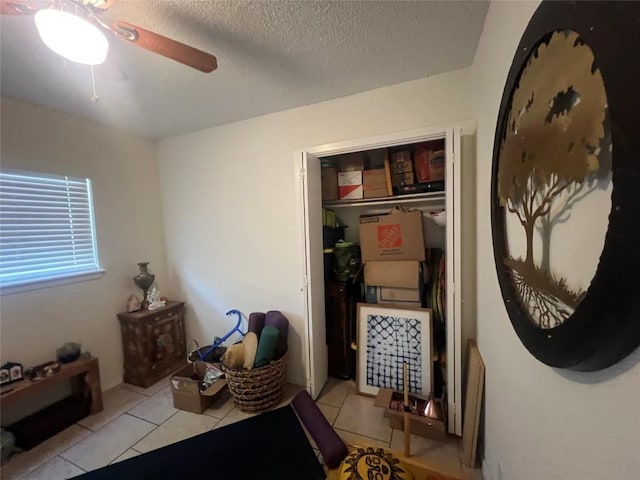 5202 Beechmoor Dr, Austin, TX 78723 - tiled bedroom with a textured ceiling, ceiling fan, and a closet