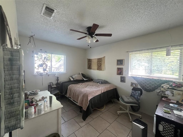 5202 Beechmoor Dr, Austin, TX 78723 - bedroom with visible vents, a ceiling fan, a textured ceiling, and light tile patterned floors