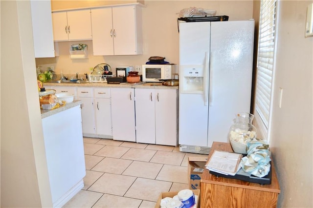5202 Beechmoor Dr, Austin, TX 78723 - kitchen featuring light countertops, white cabinets, white appliances, and a wealth of natural light