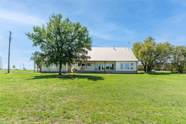 290 County Road 207, Liberty Hill, TX 78642 - rear view of house with a yard and metal roof