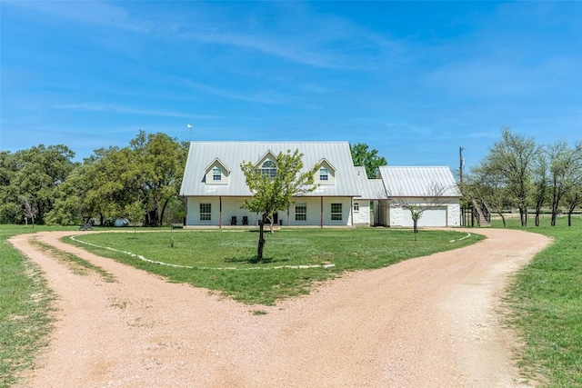 290 County Road 207, Liberty Hill, TX 78642 - view of front of house featuring dirt driveway, a garage, a front yard, and metal roof