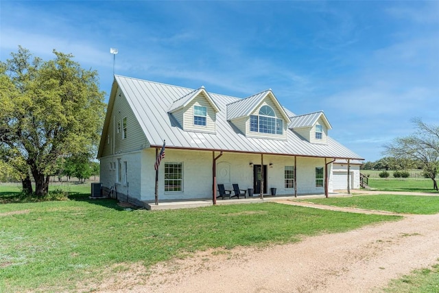 290 County Road 207, Liberty Hill, TX 78642 - view of front facade featuring cooling unit, dirt driveway, a standing seam roof, a front yard, and covered porch