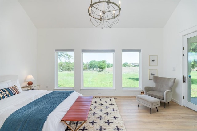 290 County Road 207, Liberty Hill, TX 78642 - bedroom with a chandelier, light wood-type flooring, and access to outside