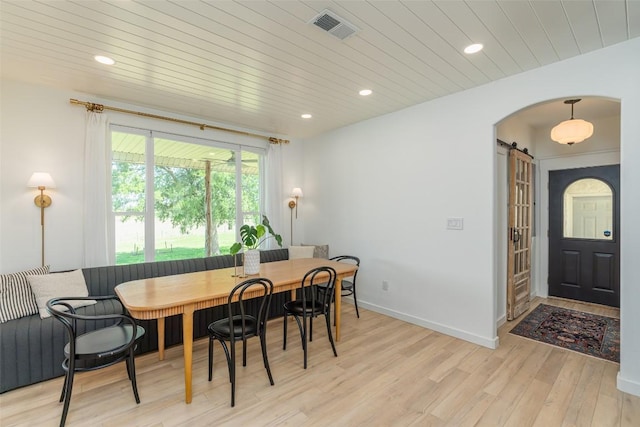 290 County Road 207, Liberty Hill, TX 78642 - dining room with breakfast area, a barn door, light wood finished floors, arched walkways, and recessed lighting