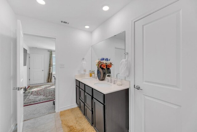 112 Gracie Way, Hutto, TX 78634 - bathroom with double vanity, recessed lighting, tile patterned floors, and baseboards