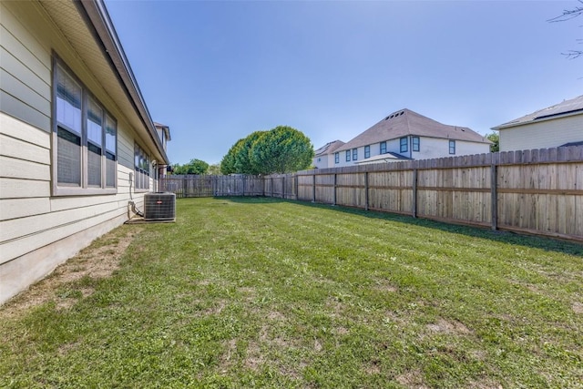view of yard featuring a fenced backyard and central AC
