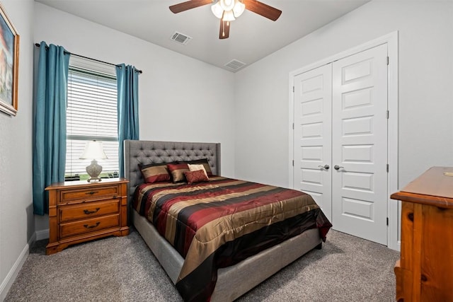 carpeted bedroom featuring a closet, visible vents, and multiple windows