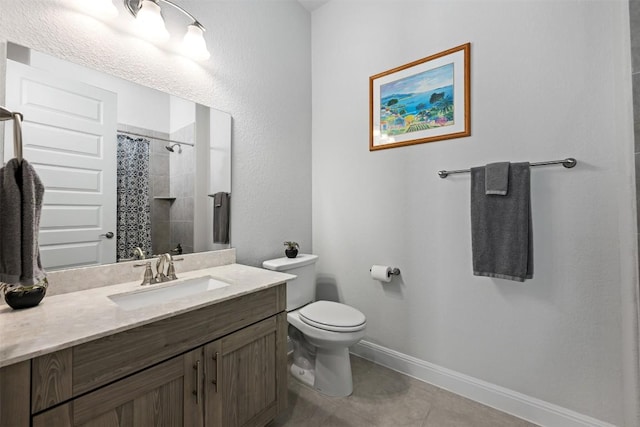 full bath with vanity, baseboards, tile patterned floors, toilet, and tiled shower