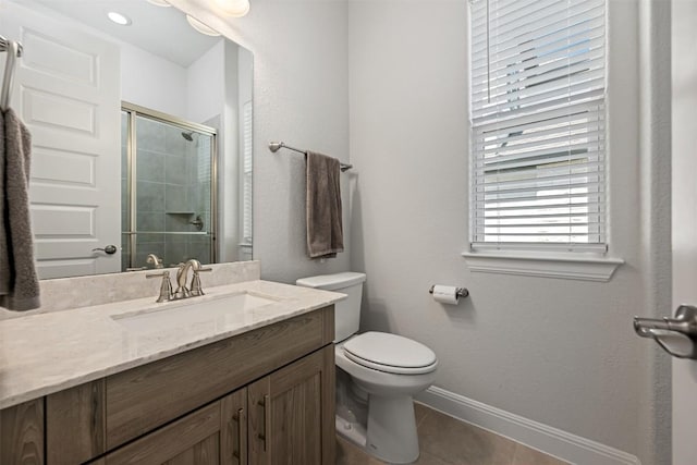 full bath with a shower stall, vanity, toilet, tile patterned floors, and baseboards