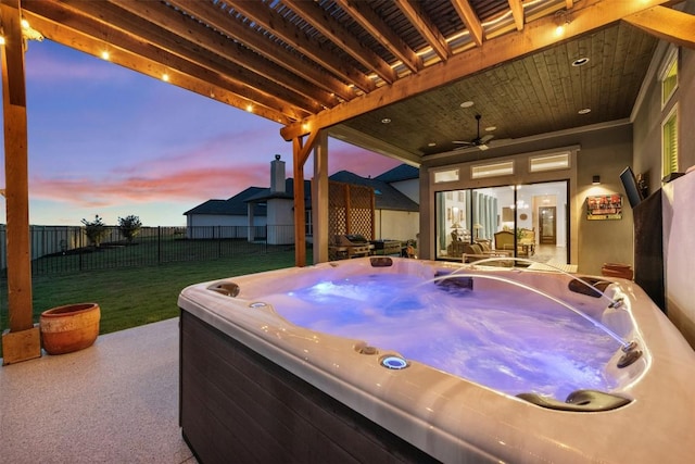 view of patio featuring a fenced backyard, ceiling fan, and a hot tub