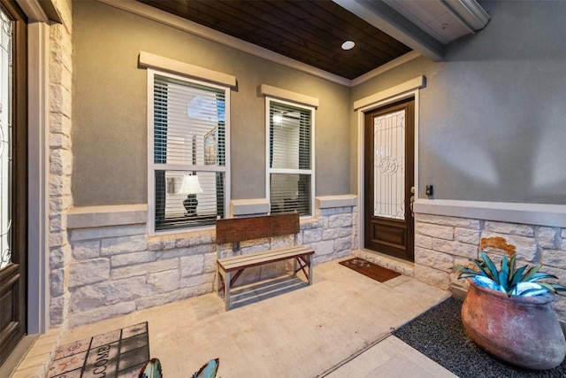 property entrance featuring stone siding and stucco siding