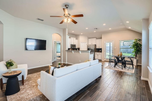 2013 Garretts Way, Manchaca, TX 78652 - living room featuring arched walkways, baseboards, dark wood finished floors, ceiling fan, and recessed lighting