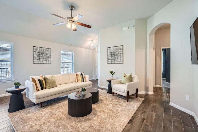 2013 Garretts Way, Manchaca, TX 78652 - living room featuring arched walkways, a ceiling fan, dark wood-style floors, vaulted ceiling, and baseboards