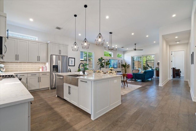 7009 Zachary Dr, Austin, TX 78724 - kitchen featuring a sink, stainless steel appliances, wood finished floors, healthy amount of natural light, and recessed lighting