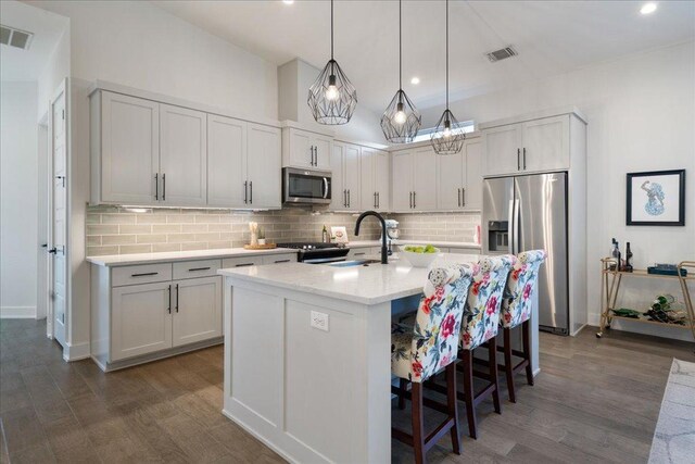 7009 Zachary Dr, Austin, TX 78724 - kitchen featuring stainless steel appliances, a sink, dark wood-type flooring, decorative backsplash, and recessed lighting