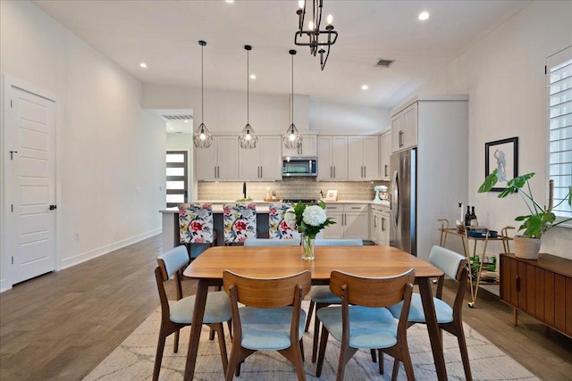 7009 Zachary Dr, Austin, TX 78724 - dining area with light wood-type flooring, recessed lighting, and a chandelier