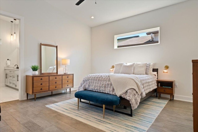7009 Zachary Dr, Austin, TX 78724 - bedroom with wood finished floors, connected bathroom, and recessed lighting