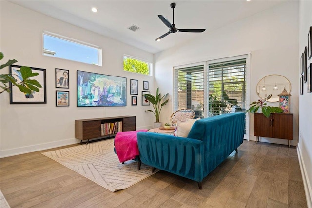 7009 Zachary Dr, Austin, TX 78724 - living room featuring wood finished floors, a ceiling fan, recessed lighting, and a high ceiling