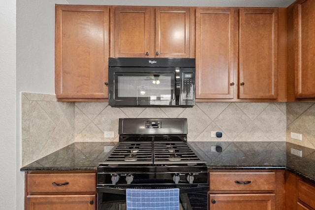 kitchen with tasteful backsplash, brown cabinetry, black appliances, and dark stone counters