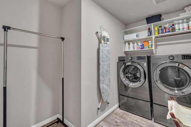 100 Vickers St, Georgetown, TX 78628 - laundry room with baseboards, separate washer and dryer, laundry area, and wood finished floors
