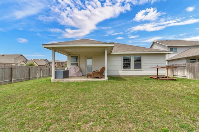 100 Vickers St, Georgetown, TX 78628 - rear view of property featuring a fenced backyard, a patio area, and a yard