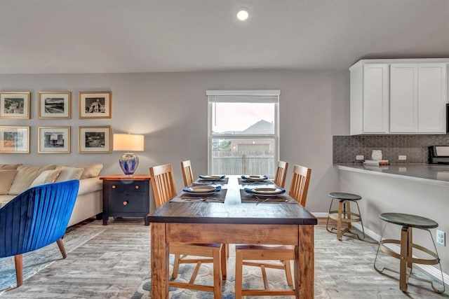 100 Vickers St, Georgetown, TX 78628 - dining area with baseboards and light wood-type flooring
