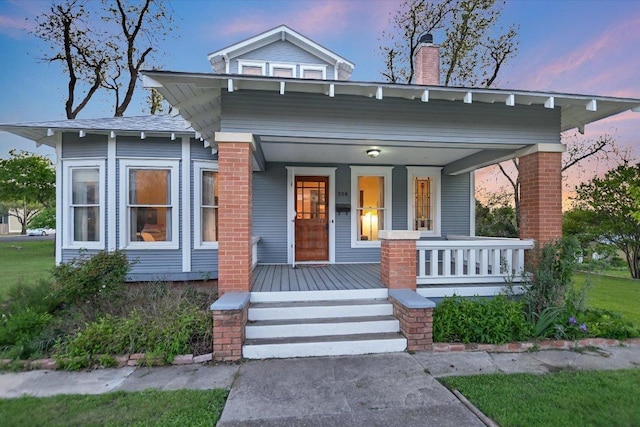 508 S Walnut St, Georgetown, TX 78626 - view of front of home with covered porch and a chimney
