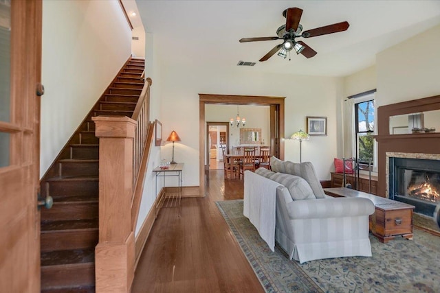 508 S Walnut St, Georgetown, TX 78626 - living area with wood finished floors, stairway, a glass covered fireplace, a ceiling fan, and a chandelier
