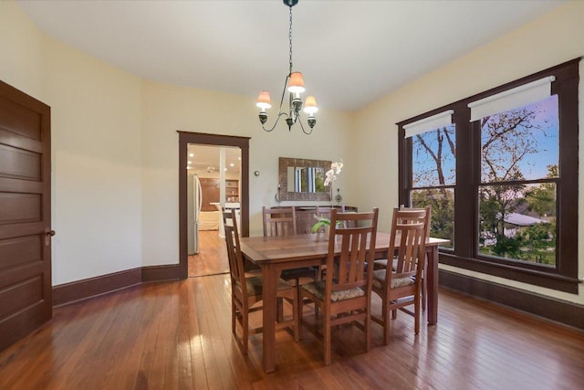 508 S Walnut St, Georgetown, TX 78626 - dining space with wood-type flooring, baseboards, and a chandelier