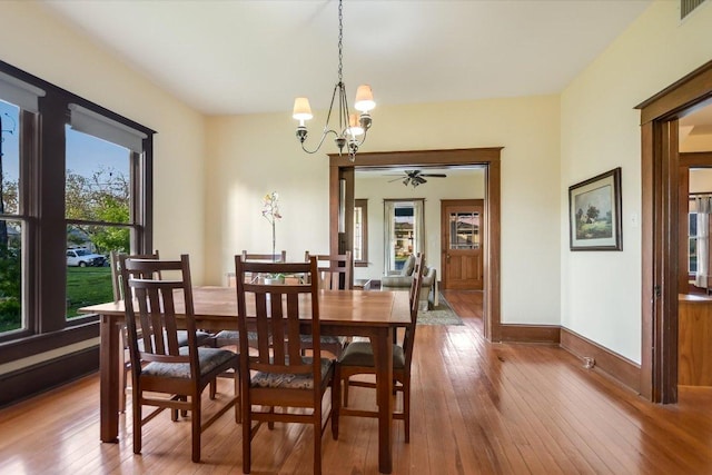 508 S Walnut St, Georgetown, TX 78626 - dining room with wood-type flooring, a chandelier, baseboards, and a ceiling fan