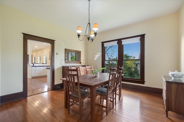 508 S Walnut St, Georgetown, TX 78626 - dining room featuring a chandelier, hardwood / wood-style flooring, and baseboards