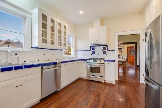 508 S Walnut St, Georgetown, TX 78626 - kitchen with appliances with stainless steel finishes, tile counters, backsplash, white cabinets, and recessed lighting