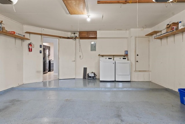 4902 Ganymede Dr, Austin, TX 78727 - garage featuring washer and clothes dryer, electric panel, and stainless steel fridge