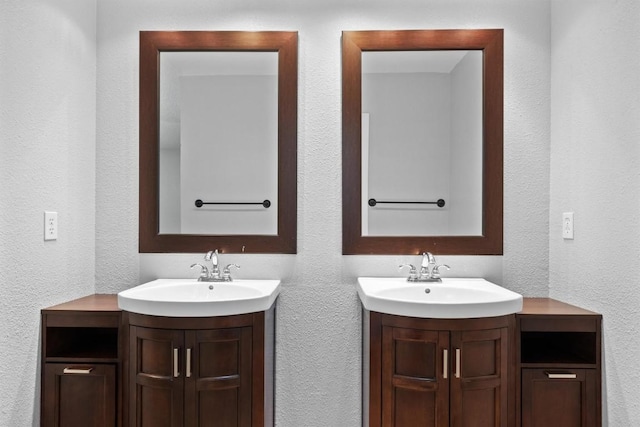 4902 Ganymede Dr, Austin, TX 78727 - bathroom featuring two vanities and a textured wall