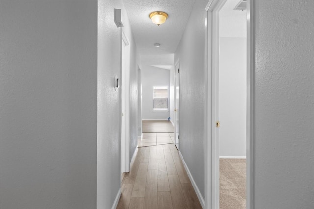 4902 Ganymede Dr, Austin, TX 78727 - corridor with a textured wall, baseboards, wood finished floors, and a textured ceiling
