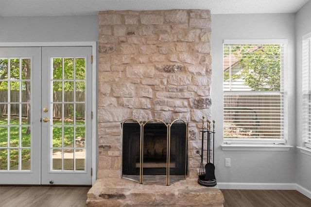 4902 Ganymede Dr, Austin, TX 78727 - detailed view of wood finished floors, french doors, a fireplace, and baseboards