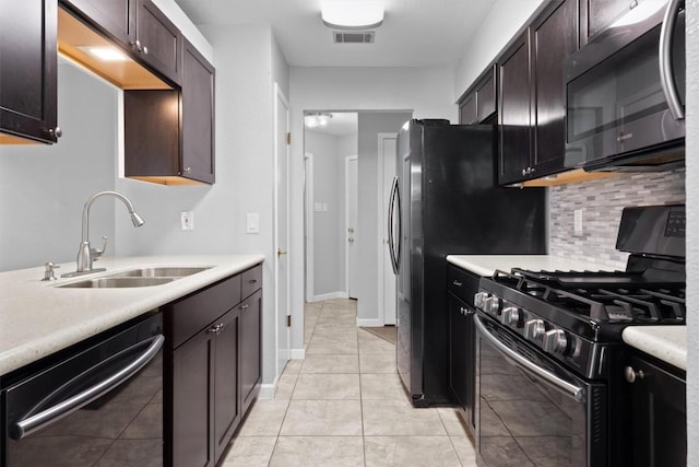 4902 Ganymede Dr, Austin, TX 78727 - kitchen featuring range with gas stovetop, dishwashing machine, a sink, backsplash, and light countertops
