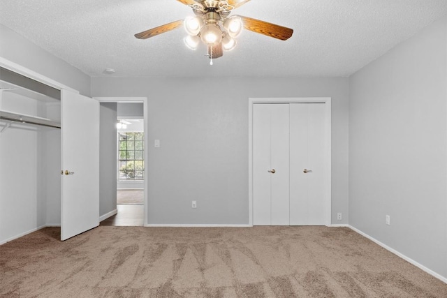 4902 Ganymede Dr, Austin, TX 78727 - unfurnished bedroom featuring multiple closets, carpet, a textured ceiling, and a ceiling fan