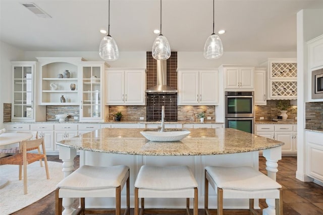 kitchen featuring open shelves, appliances with stainless steel finishes, wall chimney range hood, white cabinets, and backsplash