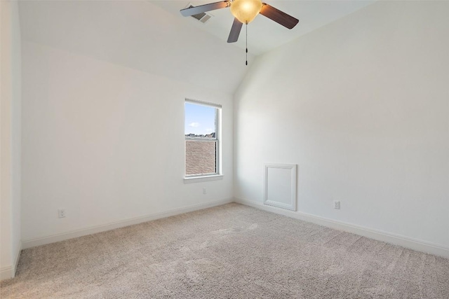 spare room with lofted ceiling, a ceiling fan, light carpet, and baseboards