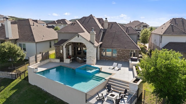 view of swimming pool with a patio area, a residential view, a fenced backyard, outdoor lounge area, and an in ground hot tub