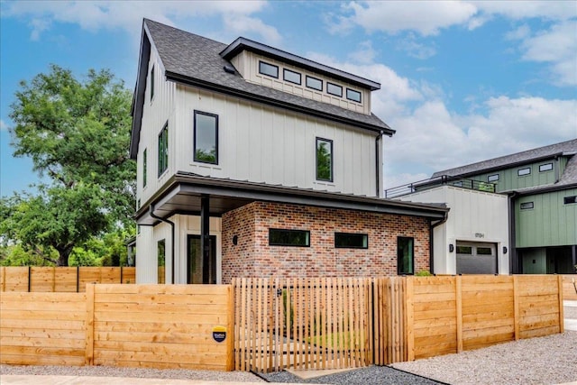 1713 E M Franklin Ave Unit 1, Austin, TX 78721 - view of front facade featuring board and batten siding, a fenced front yard, and brick siding