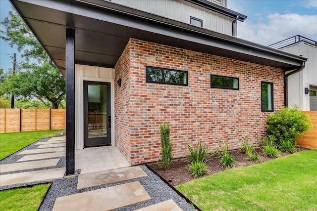 1713 E M Franklin Ave Unit 1, Austin, TX 78721 - doorway to property with brick siding and board and batten siding