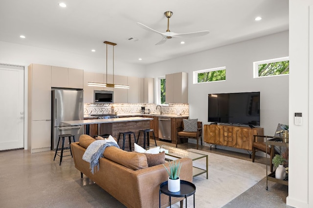 1713 E M Franklin Ave Unit 1, Austin, TX 78721 - living area featuring healthy amount of natural light, a ceiling fan, recessed lighting, and concrete flooring