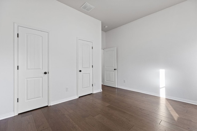 2632 Los Alamos Pass, Round Rock, TX 78665 - unfurnished bedroom with dark wood-style flooring and baseboards