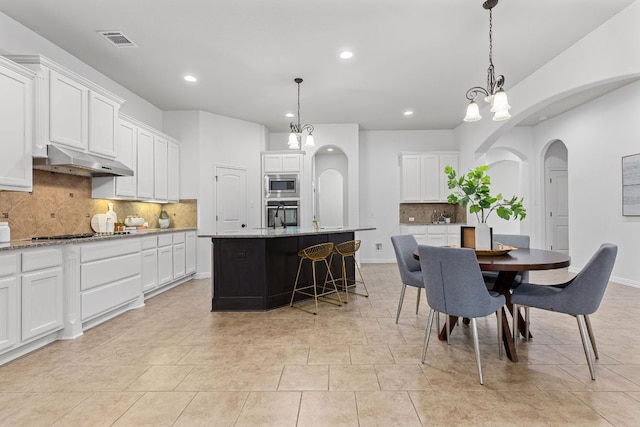 2632 Los Alamos Pass, Round Rock, TX 78665 - dining area with arched walkways, recessed lighting, and baseboards
