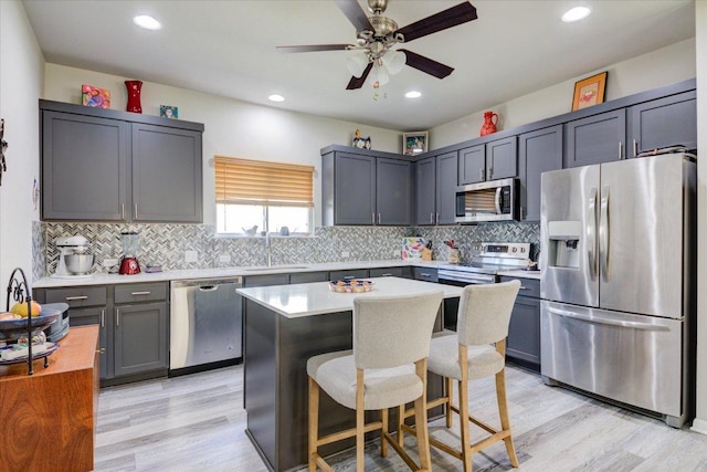 10312 Bankhead Dr, Austin, TX 78747 - kitchen featuring appliances with stainless steel finishes, a sink, tasteful backsplash, light countertops, and a ceiling fan