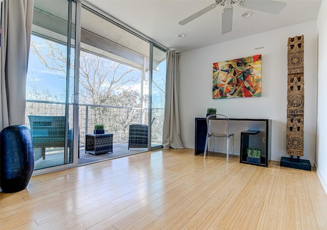 9707 Timber Ridge Pass, Austin, TX 78733 - office area featuring a wall of windows, healthy amount of natural light, a ceiling fan, and wood finished floors