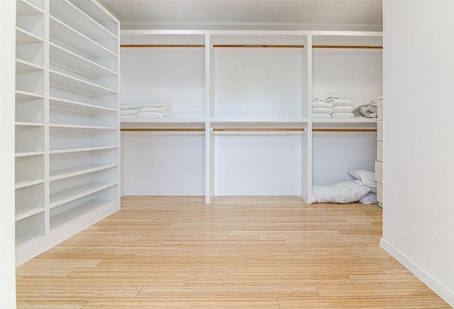 9707 Timber Ridge Pass, Austin, TX 78733 - walk in closet featuring wood finished floors