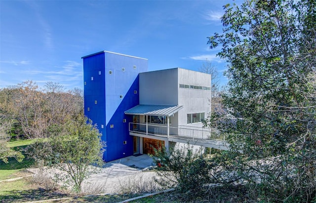 9707 Timber Ridge Pass, Austin, TX 78733 - rear view of property with a balcony and a metal roof